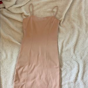 Peach color tight dress.